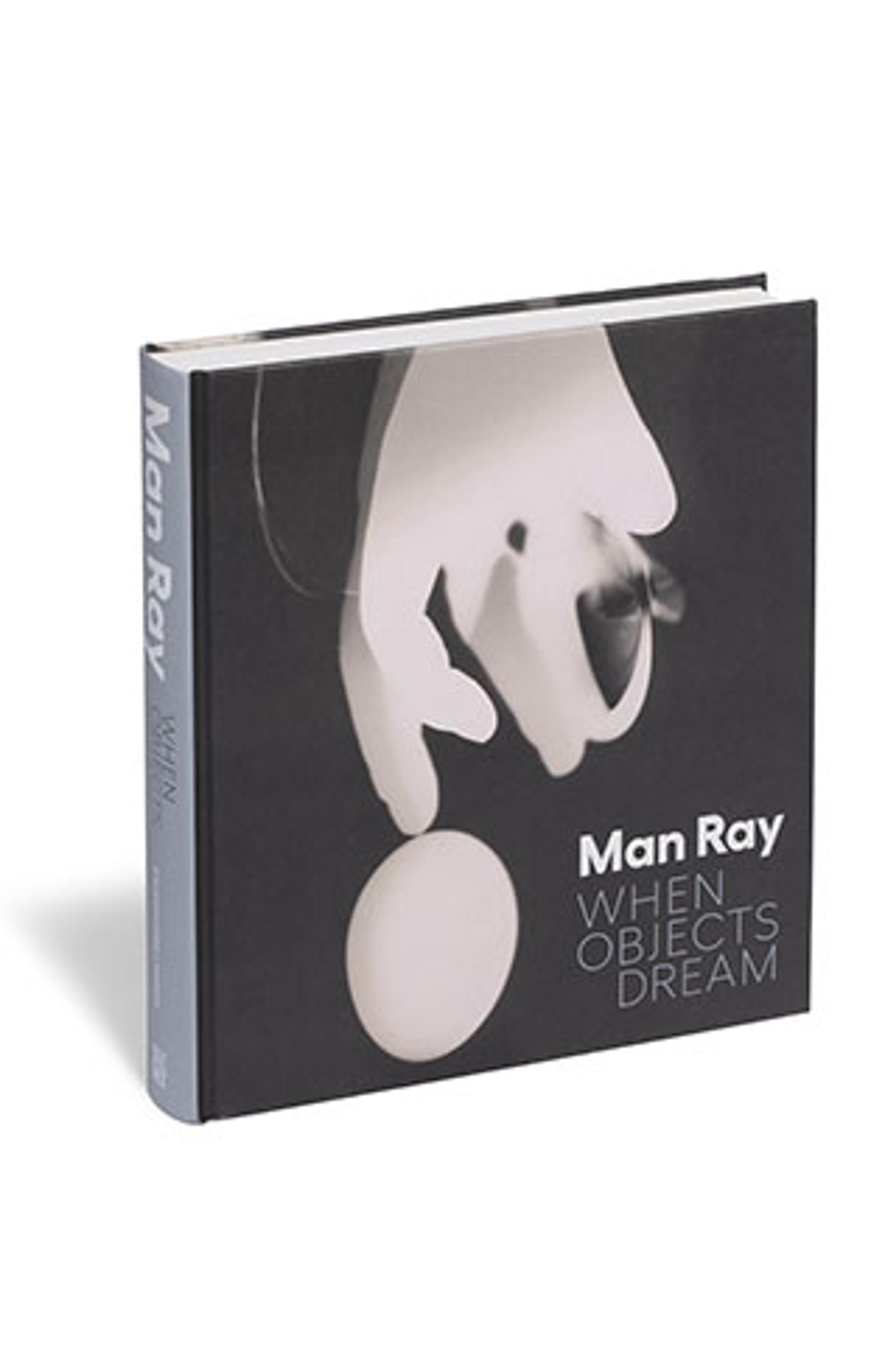 Book cover titled "When Objects Dream" by Man Ray. Features a black and white surrealist image of a hand holding a sphere, conveying mystery and intrigue.