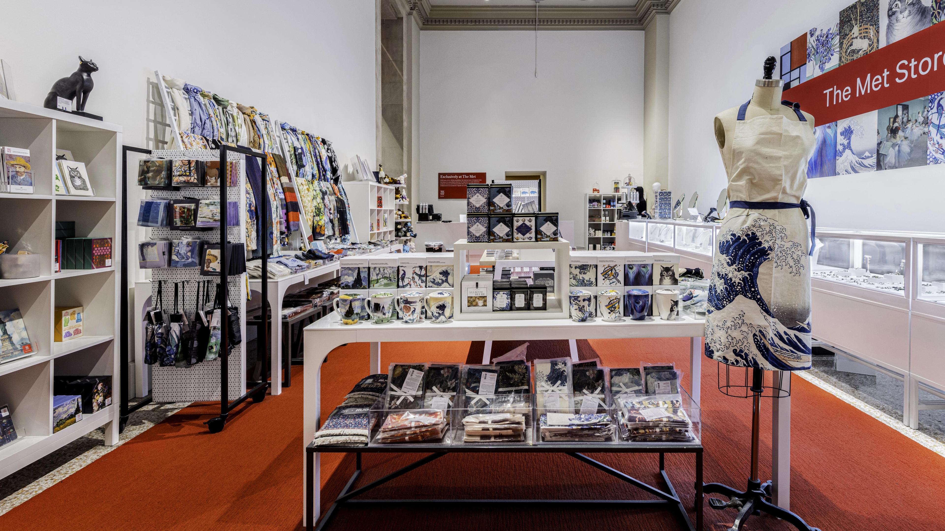 Interior of The Met Store with products on display on a table and a mannequin. 
