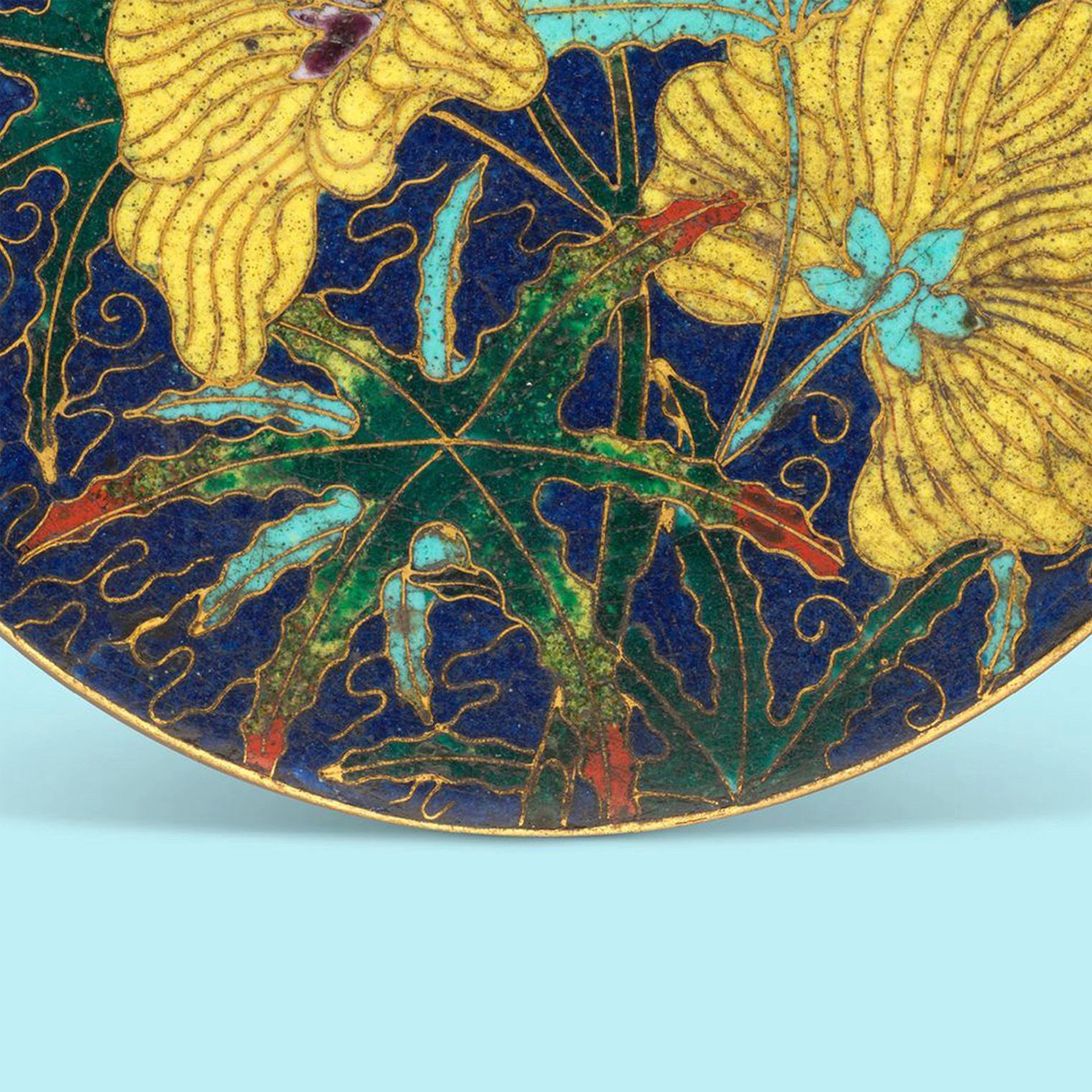 Design depicts yellow flowers with blue centers and green leaves on a deep blue background