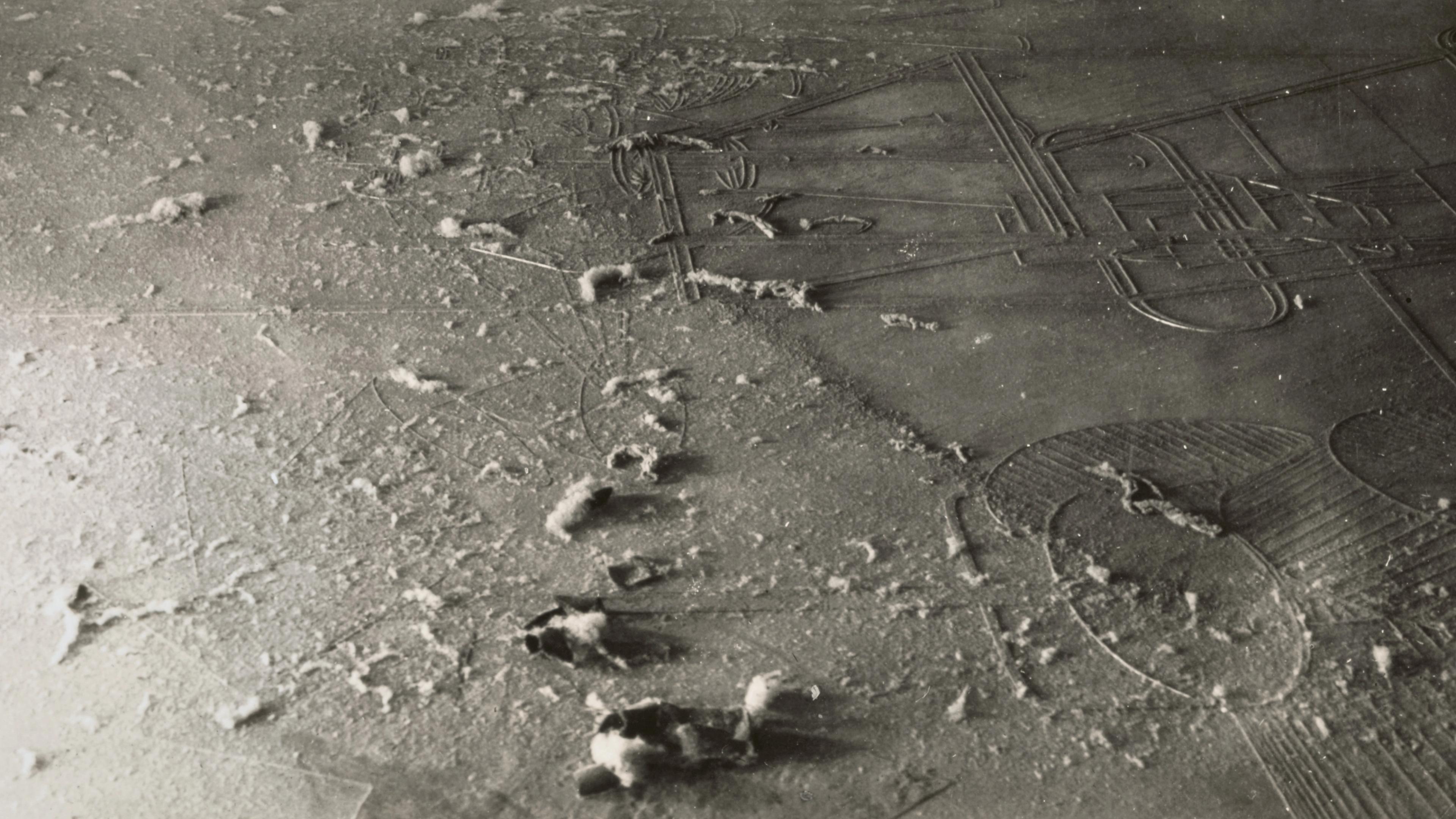 Dusty floor with intricate geometric patterns partially covered by a thin layer of dust. Soft footprints disrupt the dust, adding texture and intrigue.