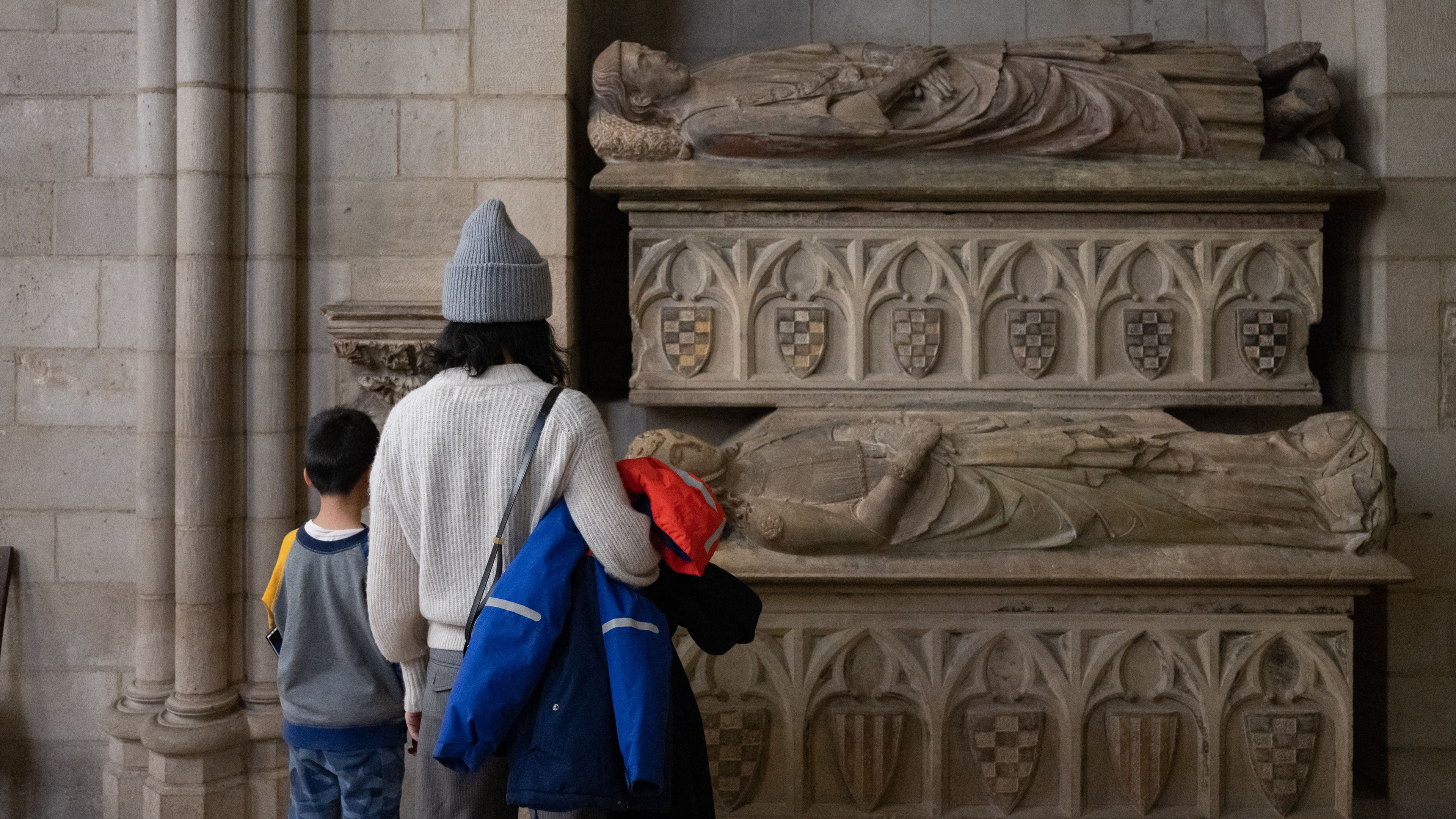 Two individuals look at objects on view at The Met Cloisters.